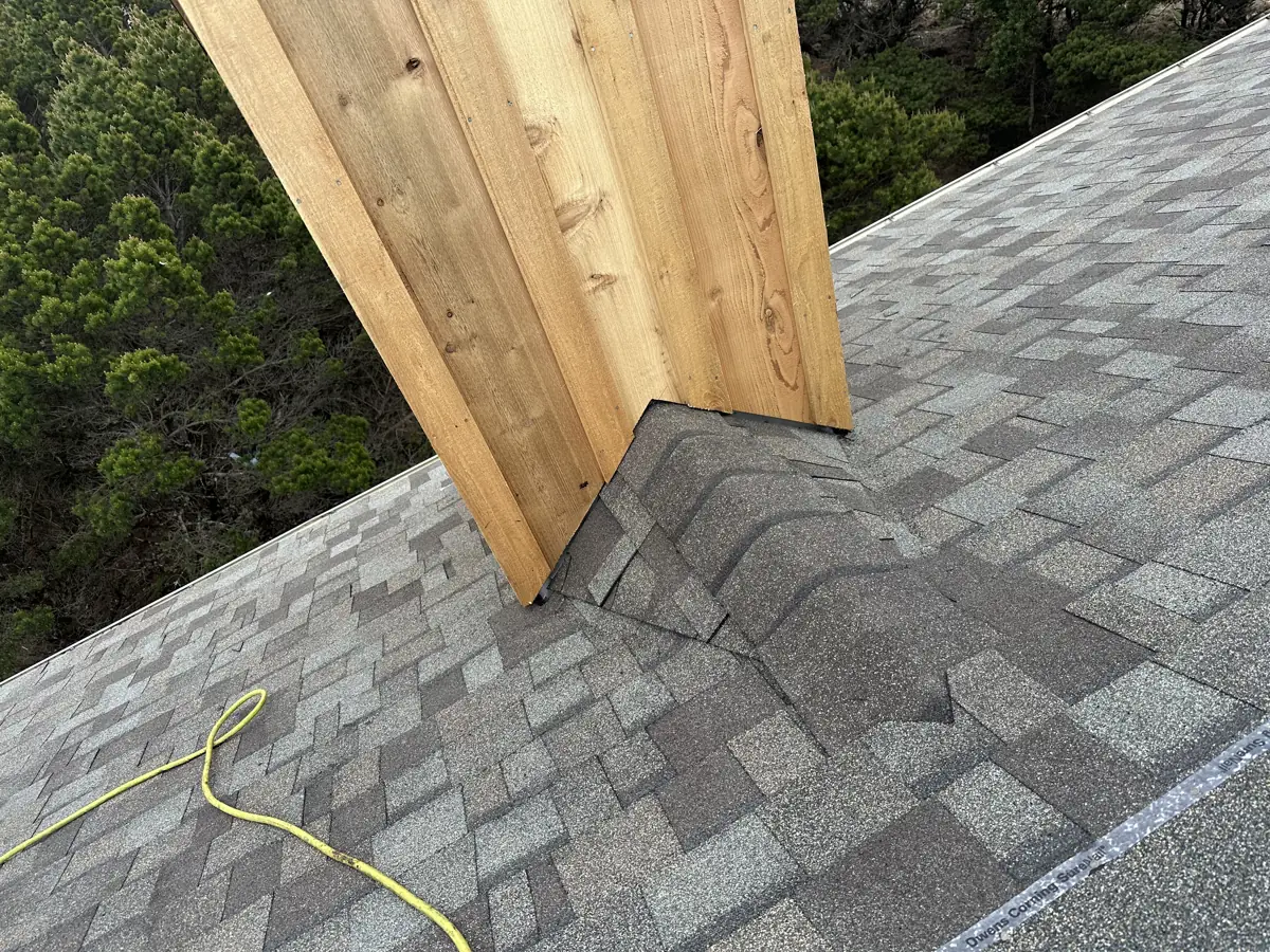 New cedar siding meeting a shingle roof